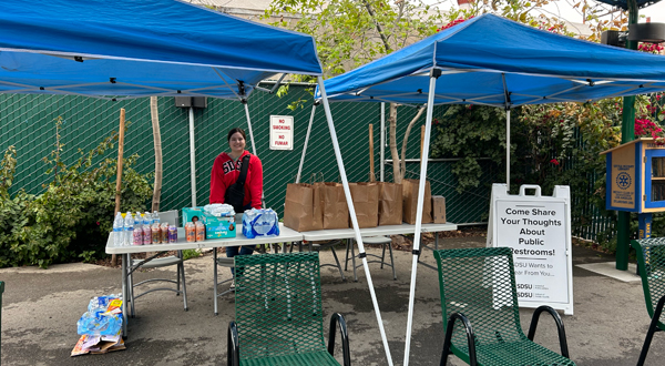 SDSU Environmental Engineering graduate student Amira Andrews sets up engagement supplies (meals, water, hygiene products) to speak with unhoused Los Angelenos about their water, sanitation, and hygiene needs at the Skid Row Community Refresh Spot, a program of Homeless Health Care Los Angeles.